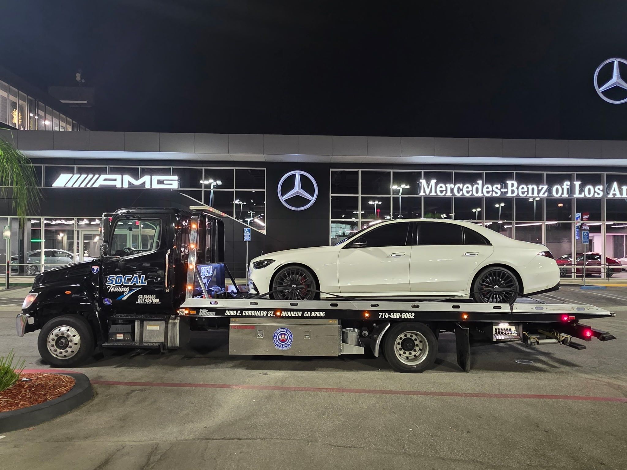 Mercedes-Benz sedan on a SoCal Towing flatbed at a Mercedes-Benz dealership